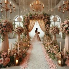 the bride is walking down the aisle with her bouquets and candles in front of her