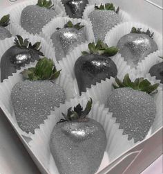 chocolate covered strawberries in a white box with silver glitter coatings on the top