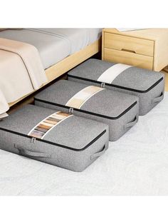 three pieces of luggage sitting on the floor in front of a bed