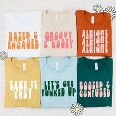 six t - shirts with different sayings on them sitting next to each other in front of a flower