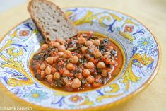 chickpeas and spinach stew in a bowl with bread on the side, ready to be eaten