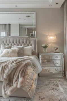 a bedroom with a bed, dresser and mirror