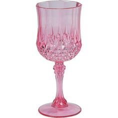 a pink wine glass sitting on top of a table