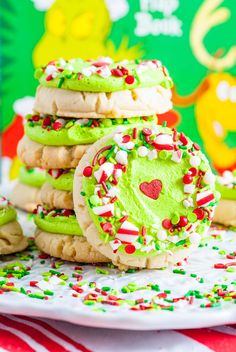 cookies with green frosting and sprinkles are stacked on top of each other