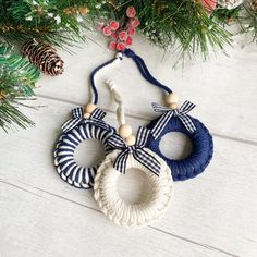 two christmas wreaths hanging from a tree