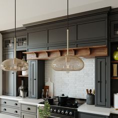 a kitchen with gray cabinets and white counter tops, hanging lights over the stove top