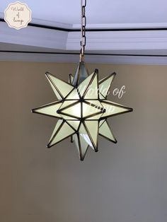 a star hanging from the ceiling with an off sign on it's front end