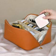 Description: Introducing our high-quality faux leather cosmetic bag, the perfect accessory for staying organized on the go. Made with soft and comfortable faux leather, this bag features a waterproof protective surface to keep your cosmetics safe from getting wet. It is also easy to clean and not prone to collapse, ensuring durability and longevity. With a top handle for easy portability, this toiletry bag can hold all your full-sized cosmetics, makeup tools, toiletries, or travel essentials. Th Square Makeup Bag, Square Makeup, Beg Tangan, Leather Cosmetic Bag, Sac Lunch, Travel Storage Bag, Toiletries Organization, Travel Storage, Toiletry Bag Travel