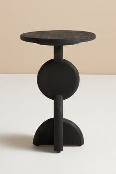 a black table sitting on top of a white counter