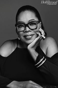 a black and white photo of a woman wearing glasses