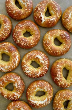 many bagels with white powdered sugar on them are lined up in a row