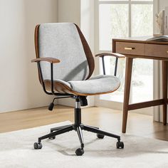 an office chair sitting on top of a white rug next to a wooden desk and window