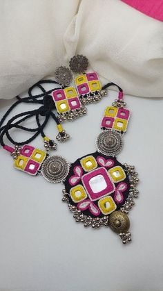 a pink and yellow necklace with matching earrings