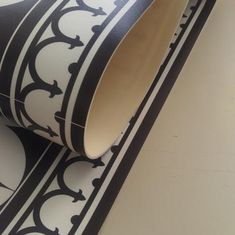 a black and white wallpaper with an ornate design on it's sidewall