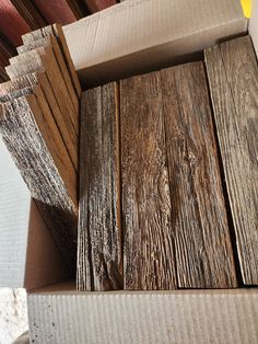 several pieces of wood sitting in a cardboard box