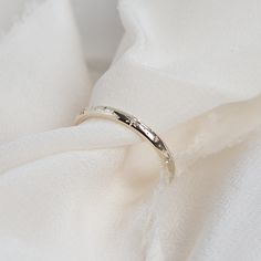 a white cloth with a silver ring on it