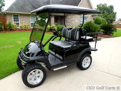 a black golf cart parked in front of a house