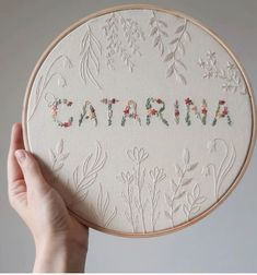 someone is holding up a embroidery kit with the word catarina written in it