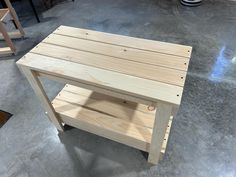 a wooden table sitting on top of a cement floor