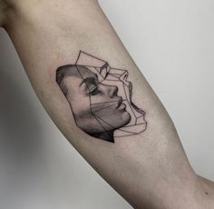 a man's arm with an abstract portrait tattoo on it