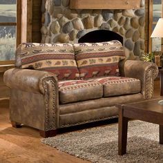 a living room filled with furniture and a fire place in front of a stone fireplace