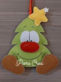 a green christmas tree ornament hanging on a wall