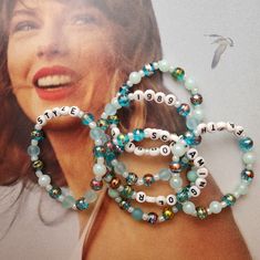 two bracelets with words on them are next to a photo of a woman's face