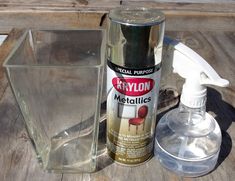 a spray bottle next to a glass container on top of a wooden table with other items