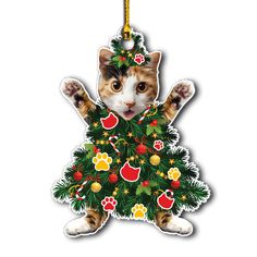 a cat hanging from a christmas tree ornament