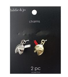 two pieces of silver and red earrings on black background with white text that reads,'hide & jo charms 2 pc '