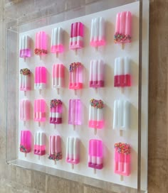 an ice cream display with pink, white and sprinkles