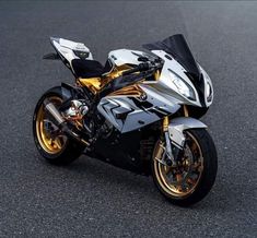 a silver and black motorcycle parked on the street