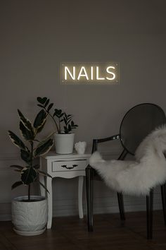 a white chair sitting next to a potted plant