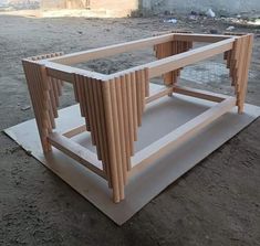 a wooden structure sitting on top of a cement ground