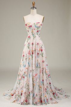 a white dress with floral print on it and a mannequin headdress