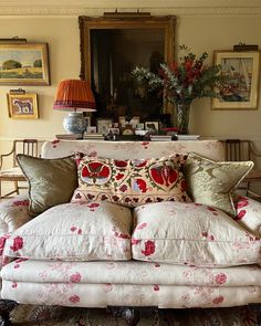 a living room filled with furniture and pictures on the wall