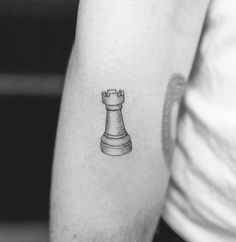 a black and white photo of a chess piece on the arm, with an outline of a pawn