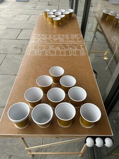 there are many cups on the table that have been set up for people to drink