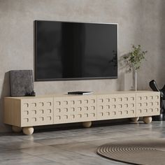 an entertainment center with a flat screen tv mounted on it's sideboard in a living room