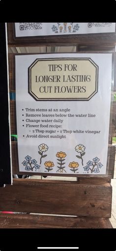 a sign that says tips for long - lasting cut flowers on the side of a wooden bench