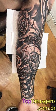 a man's arm with roses and an old pocket watch tattoo on the forearm