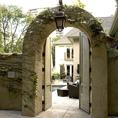 an open door leading to a house with a patio and sitting area in the background