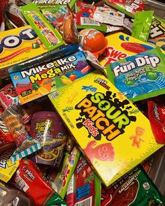 a pile of assorted candy and snacks in a bin with the words fun dip on it