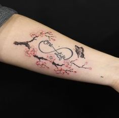 a woman's arm with a tattoo on it that has the word love and flowers