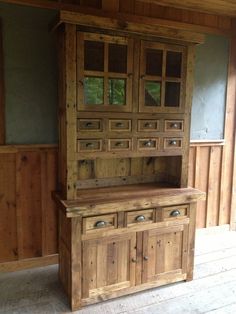 a large wooden cabinet sitting inside of a room