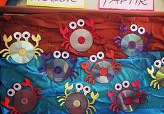 an assortment of cds and crab magnets on a bulletin board