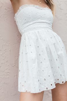 Our Lainey Eyelet Mini Dress has a strapless, sweetheart design with delicate ruffle detailing and a zipper closure. True to Size 100% Cotton Ruffle Neckline Lined Hand Wash, Hang Dry Patriotic Tees, Strapless Tops, Denim Shop, White Mini Dress, Swimsuit Tops, Shoes Heels Boots, Denim Dress, Short Sleeves Tops, Jumpsuit Romper