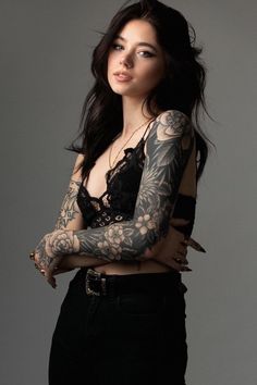 a woman with tattoos on her arm and arms