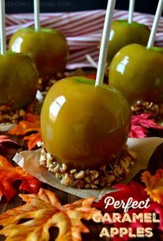 caramel apples are sitting on top of leaves and candy sticks with the words perfect caramel apples above them