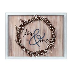 a wooden sign with the words you and me on it in front of a white frame